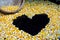 Corn made â€‹â€‹a heart shape on a black background.