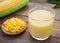 Corn milk in glass, kernel corn on plate and fresh corn
