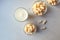 Corn sticks in a glass dish with a glass of milk on a light background, top view-the concept of quick healthy snacks