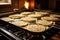 corn tortillas cooking on a stove-top griddle