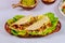 Corn tortillas with green lettuce, beef and guacamole. Mexican food