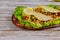 Corn tortillas with green lettuce, chicken on wooden table. Mexican food