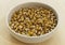 Corn in a white bowl on wooden table