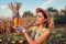 Corn. Young woman farmer picking corn harvest. Worker holding autumn corncobs. Farming and gardening