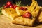 Cornbread on a wooden board with dried tomato and cherry tomatoes