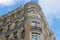 Corner of beige classical building on Gran Via street in Madrid, Spain