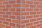 Corner brick wall with running bond pattern.