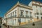 Corner of colorful house with big windows and iron balconies