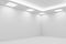 Corner of empty white room with square ceiling lights