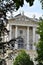 Corner of historic building, in the museum district in Vienna, with portico and statues.