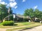 Corner house with American flag and for sale sign at neighborhood suburbs Dallas, Texas, USA