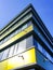 Corner of the modern office house with surveillance cameras on blue sky background