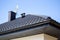 Corner of the new modern house with roof, gutter, ventilation chimneys and satellite dish