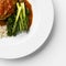 Corner of a plate of Asparagus and Broccoli on a white plate, an