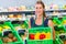 Corner shop clerk filling up storage racks