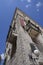 Corner of a stone building with balconies and a lamppost, in Croatia, Europe, located next to the mouth of the river Krka