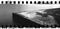 Corner stone pier Sydney Harbour NSW Australia night wide panorama monochrome city lights reflecting on water on surface sprockets