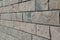 The corner structure of the house. Texture - artificial decorative stone faÃ§ade. grey color rough stone wall background texture.