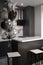 Corner of stylish Minimalistic grey kitchen, dark gray cupboards, white countertops and bar with stools. black and white balloons