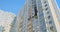 Corner tall residential building. Black window, apartment after the fire. Low angle, panorama.