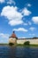 Corner tower of medieval Shlisselburg Oreshek fortress on the island in the Ladoga lake in Russia against blue sky