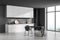 Corner view of minimalist grey kitchen with round black dining table
