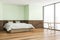 Corner view of trendy light green bedroom