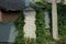 The corner of the wall of a house made of white bricks and gray metal