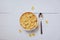 Cornflakes breakfast in bowl and spoon on wooden background - cereal healthy food