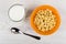 Cornflakes in form star in bowl, milk and spoon