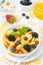 Cornflakes, fresh berries and orange juice for breakfast