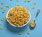 Cornflakes in a white ceramic plate and an iron spoon