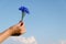 Cornflower bouquet female hand blue sky background