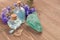 Cornflower flower blue water in glass bottles, natural stones and flowers on brown wooden background