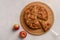 Cornish apple pie with a cut piece on the shoulder blade top view on rustic style white background. Next to two apples