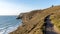 Cornish coastal path, in the summer, with a derelict tin mine in the distance