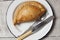 Cornish pasty on a white enamel plate