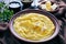 Cornmeal polenta with melting butter in a bowl