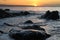 Cornwall sunrise across rocks and sea