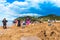 COROMANDEL, NEW ZEALAND - OCTOBER 13, 2018: Tourists dig holes in the volcanic sand on the Hot Water beach