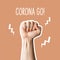 Corona go. Male fist symbol of fighting coronavirus epidemic on orange background. Flat lay