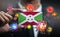 Corona Virus Around Burundi Flag. Concept Pandemic Outbreak in Country