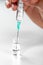 Corona virus COVID-19 vaccine and injection syringe in hand