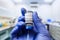 Corona virus vaccine in researcher hand in laboratory