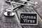 CORONA VIRUS word written on blackboard with Stethoscope on wood background