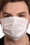 Corona virus. Young guy in a mask on a white background. Protection against viruses, infections, exhaust fumes