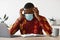 Coronacrisis Concept. Stressed Black Man In Medical Mask Looking At Laptop Screen
