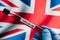 Coronavirus blood sample test result against UK national flag. Contagious disease spreading. Epidemic in Britain. Coronavirus 2019