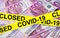 Coronavirus and business concept, caution tape on euro money stack, world economy hits by corona virus outbreak