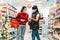 Coronavirus. The cashier serves the customer at the checkout. Both women are wearing medical masks. The concept of protection from